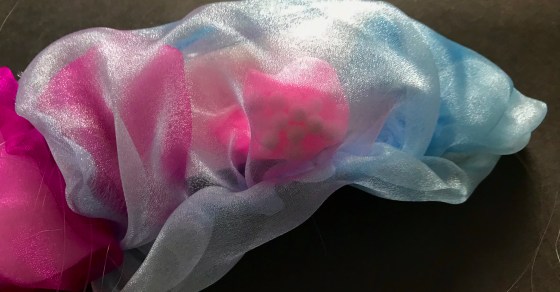 Close up of an assemblage piece by MJ Seal made of various plastics that resembles a colorful, translucent sea creature